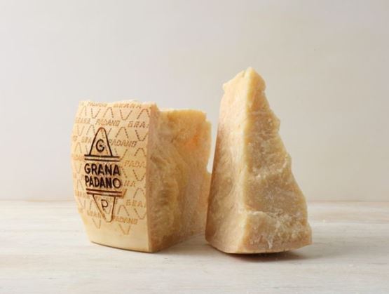 Two pieces of Grana Padano with visible rind branding.