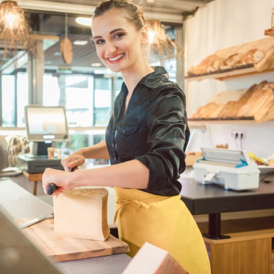 a woman cutting cheese