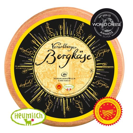 A piece of Vorarlberger Bergkäse with medals on a white background.