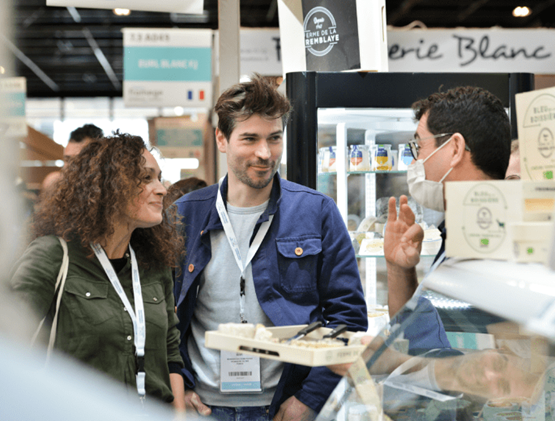 Visitors talking with an exhibitor. 